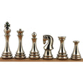 Six silver polished brass metal luxury chess pieces displayed in a row on a wooden beam.