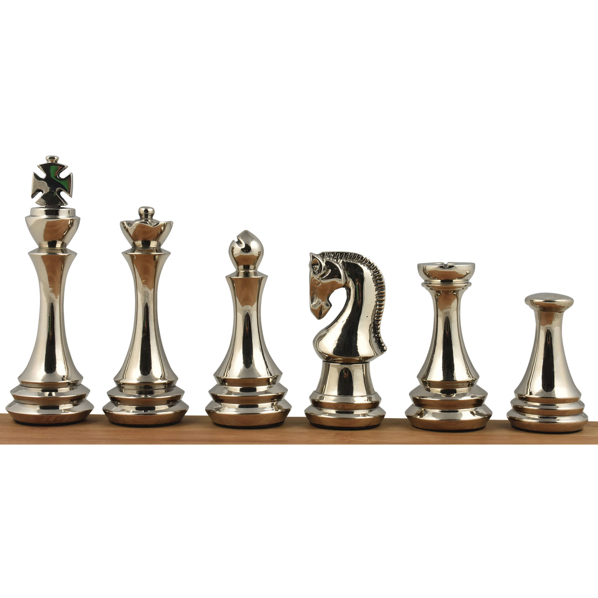 Six silver polished brass metal luxury chess pieces displayed in a row on a wooden beam.