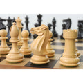 Close-up of a hand-carved white Staunton knight on a wooden chessboard.
