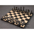 Complete 4.3 inch Staunton brass metal luxury chess pieces arranged on a black and maple wood board.