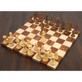 Complete 3.7" British Staunton weighted chess set arranged on a wooden board with the white queen advanced.