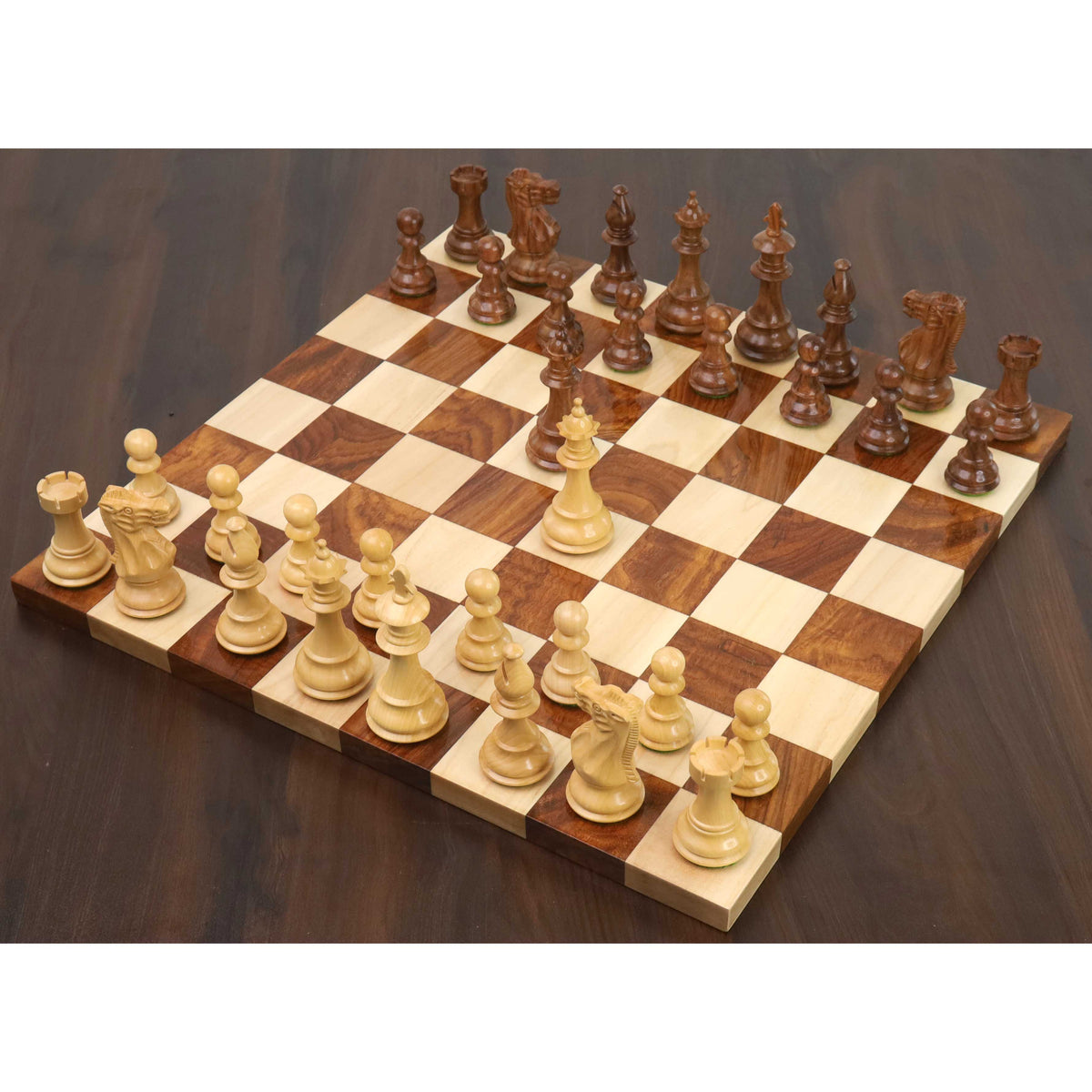 Complete 3.7" British Staunton weighted chess set arranged on a wooden board with the white queen advanced.