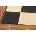 Macro view of the 55mm squares on an Ebony and Maple wood chess board highlighting the natural wood grain and matte texture.