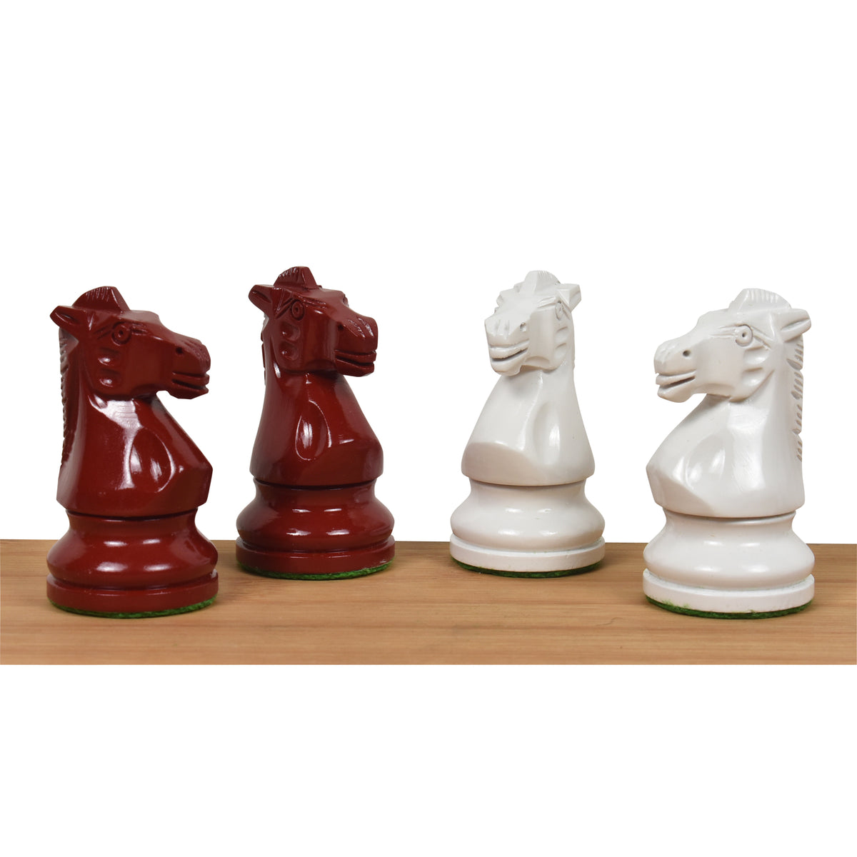 Two burgundy and two white lacquered boxwood Prime Staunton knights facing each other, highlighting their carved details.