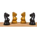 Four 1852 Harrwitz Staunton knights in ebony and antiqued boxwood facing each other.