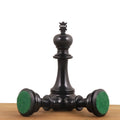 Triple weighted Prestige Luxury chess pieces shown from the bottom to highlight the green felt bases.