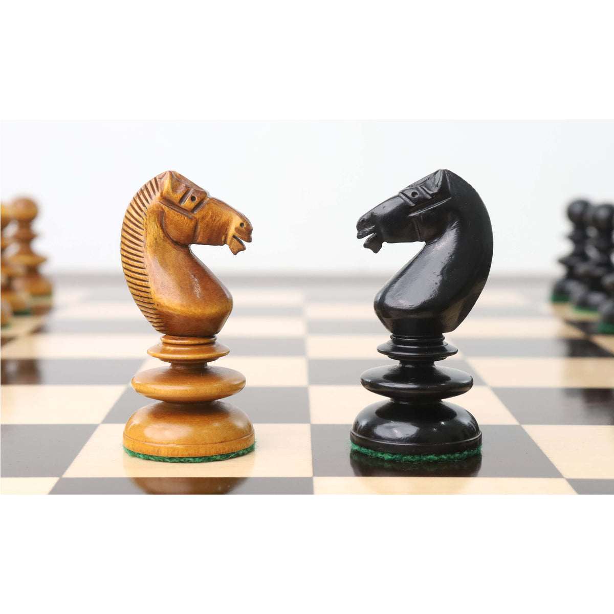 Light and dark knights engaged on the St. John Pre-Staunton chess board.