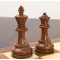 Close-up of golden rosewood king and queen from the Reykjavik Series Staunton chess set on a board.