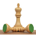 Boxwood Imperial Staunton king standing next to two fallen pieces revealing green felt bases.