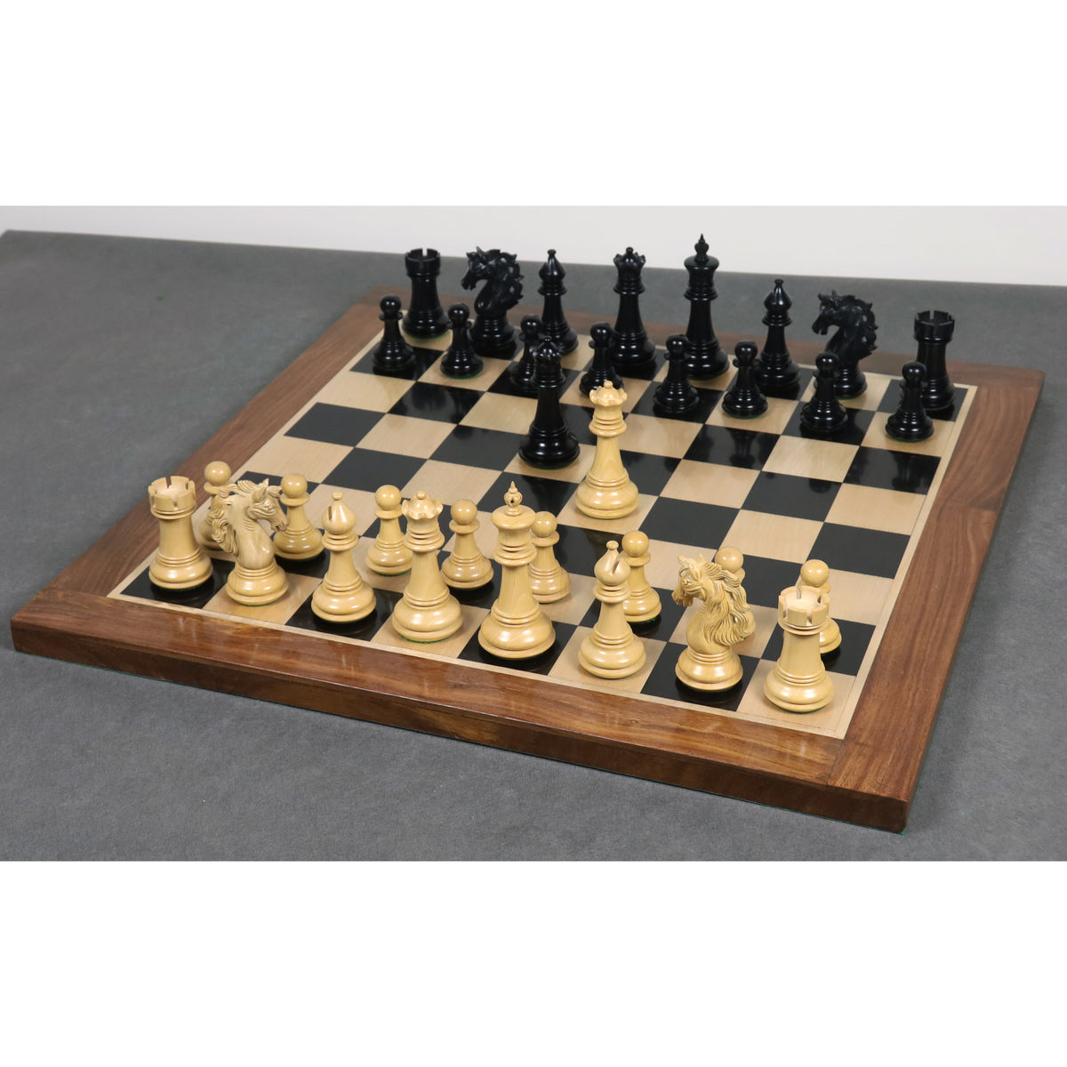 Full set of Spartacus luxury Staunton ebony wood chess pieces arranged on a wooden board.