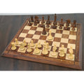 Full Alban Knight Staunton chess pieces set set up on a luxury wooden chessboard.