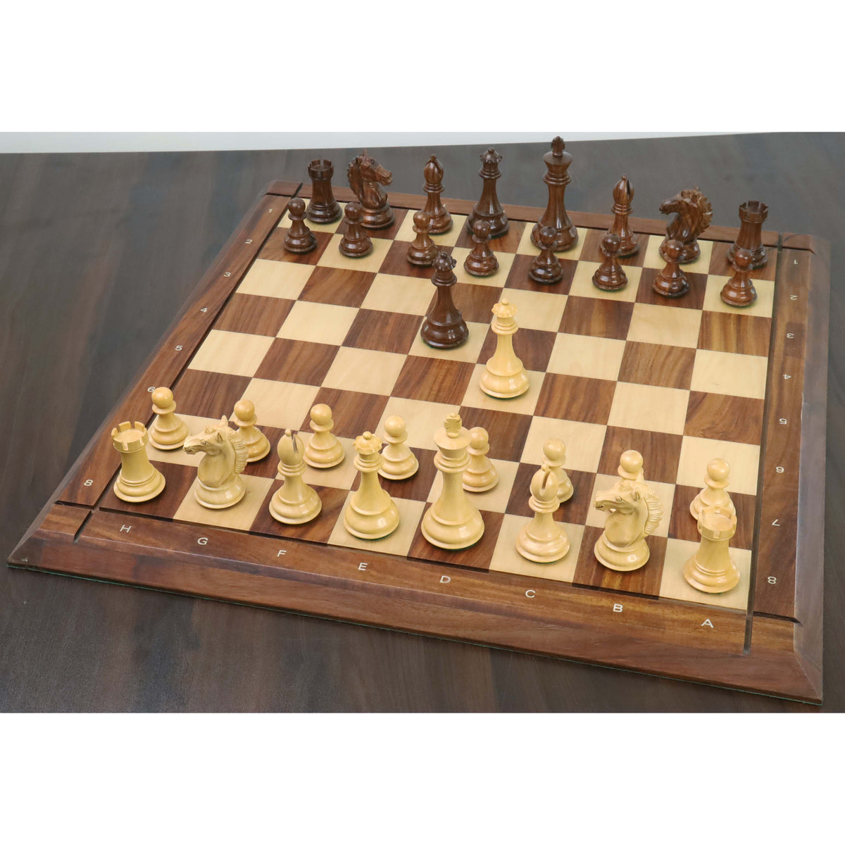Full Alban Knight Staunton chess pieces set set up on a luxury wooden chessboard.