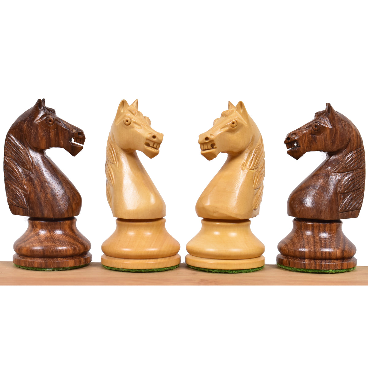 Golden rosewood and boxwood French Grandmaster knight chess pieces lined up together.