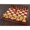 Complete sleek Staunton luxury chess pieces set up for a game on a premium wooden board.