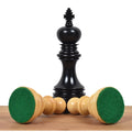 Black ebony King chess piece highlighting weighted green felt base.