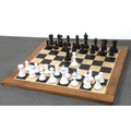 Complete Pro Staunton black and white lacquered wooden chess pieces set displayed on a wooden board.