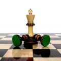 Boxwood Parker Staunton king piece on a gloss chessboard with tipped pieces displaying thick green felt bases.