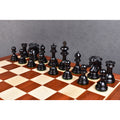 The full collection of dark ebony Alexandria Staunton chess pieces arranged on a wooden chessboard.