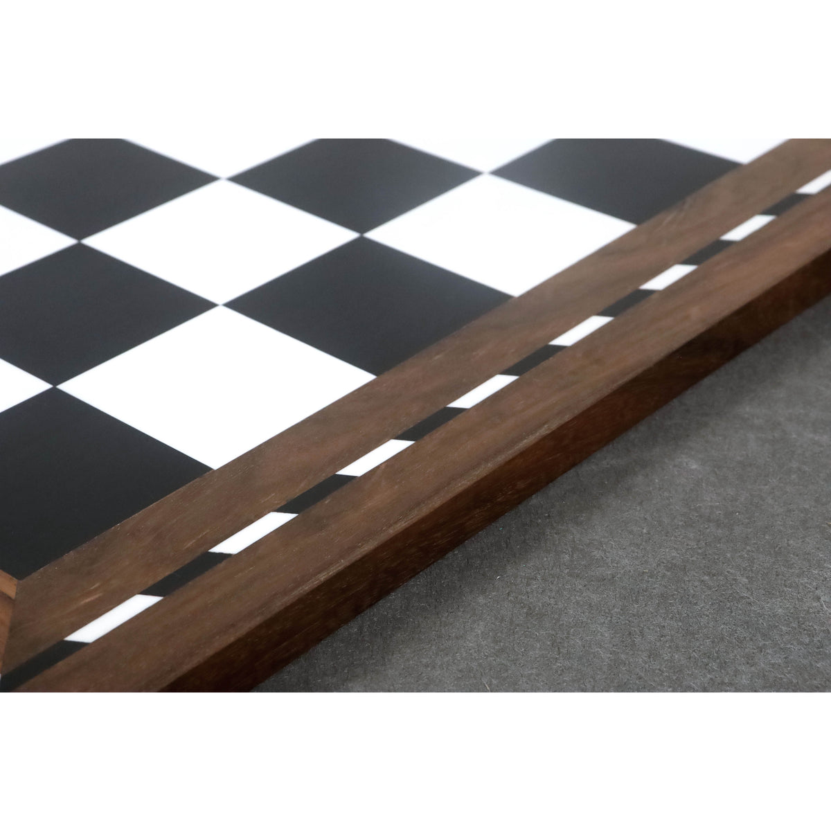 Detail shot of the polished Golden Rosewood border and decorative inlay on the library chess board.