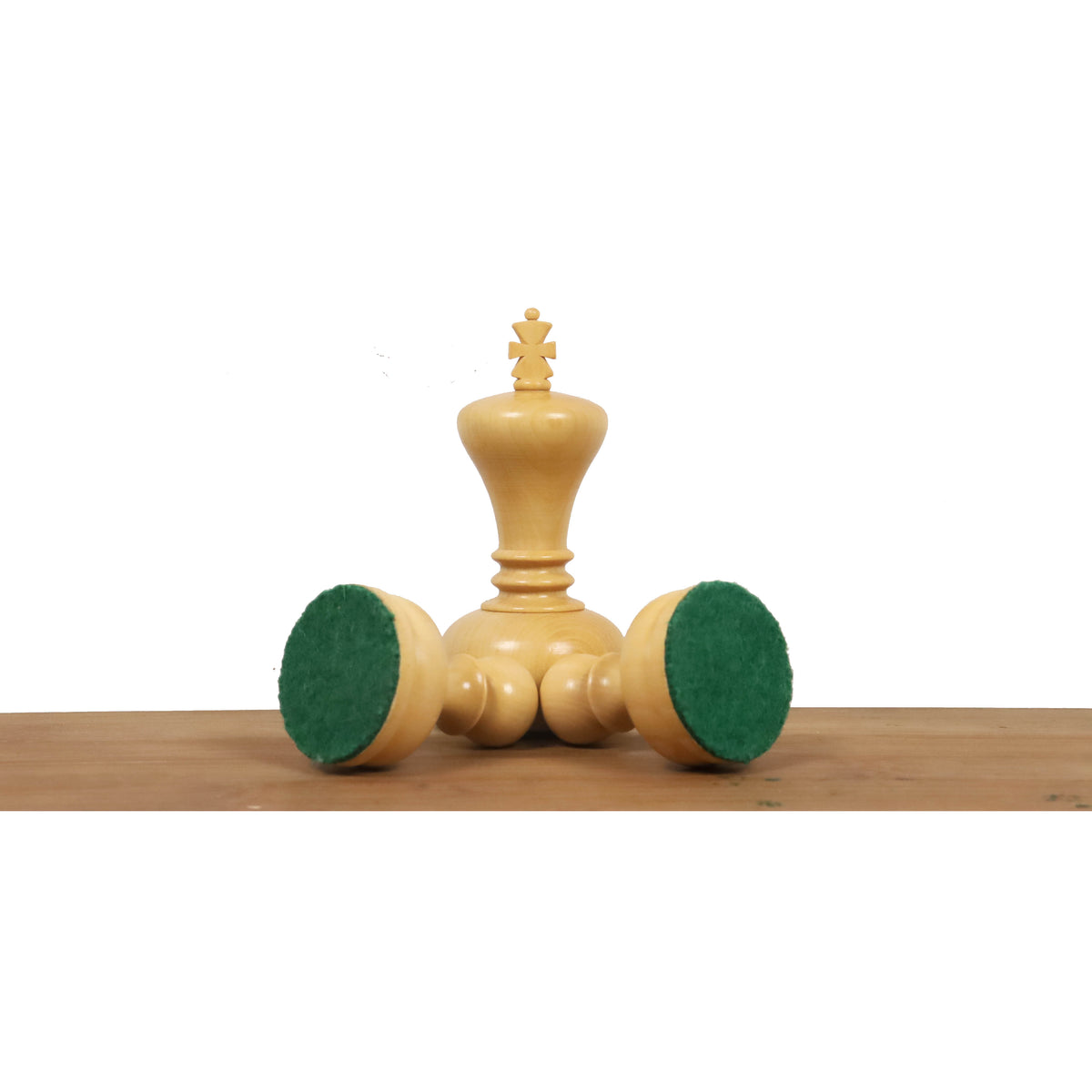 White boxwood King piece showcasing the green felted base for surface protection and stability.