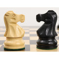 Close-up of ebonised boxwood king and queen from the Reykjavik Series Staunton chess set on a board.
