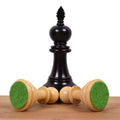 Ebonised boxwood king piece displaying its weighted green felt base.