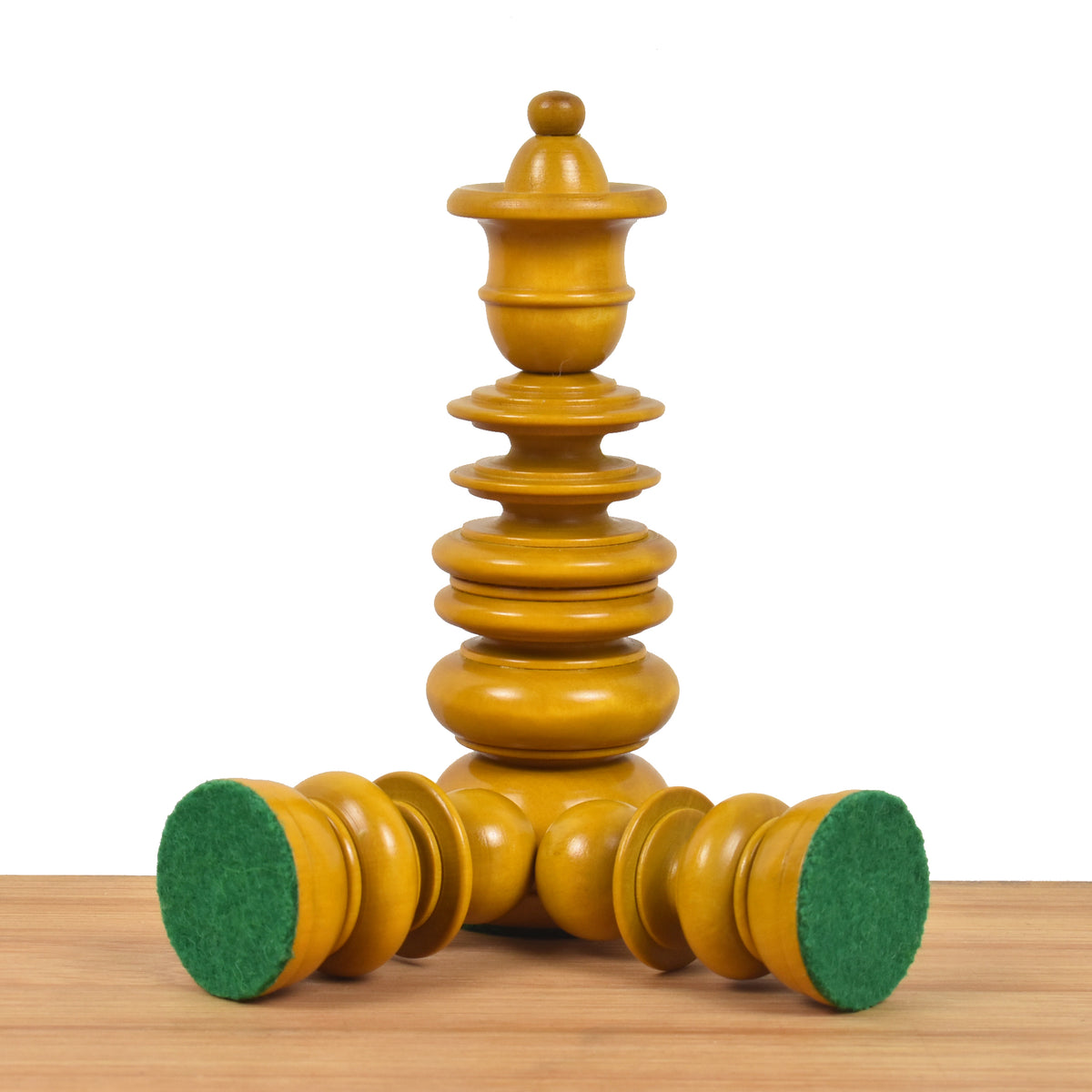 Antiqued boxwood chess pieces illustrating the protective green felted base padding.
