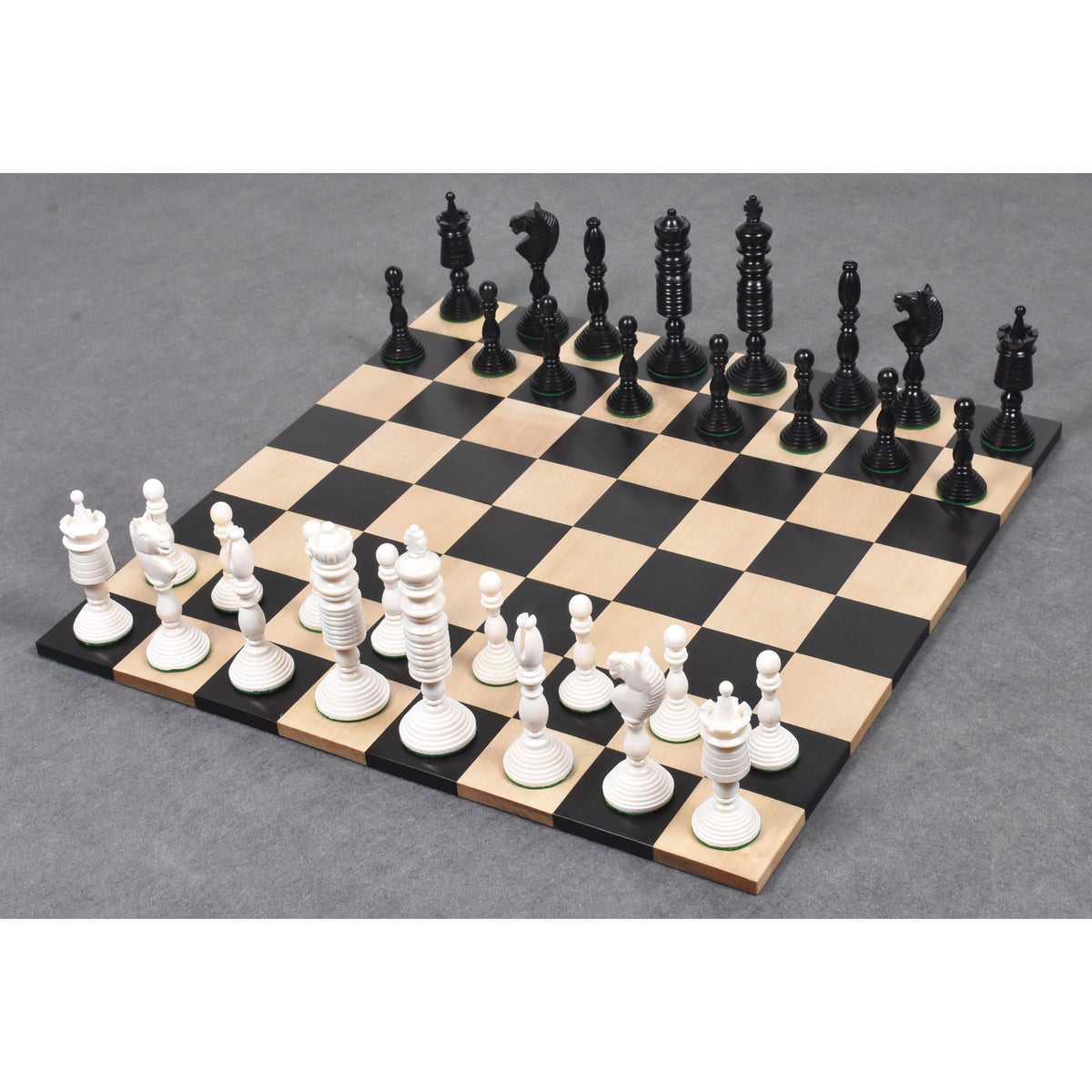 Complete antique pre-Staunton English chess set arranged on a wooden board.