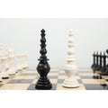 Close-up of black and white Turkish Tower king pieces on a chessboard