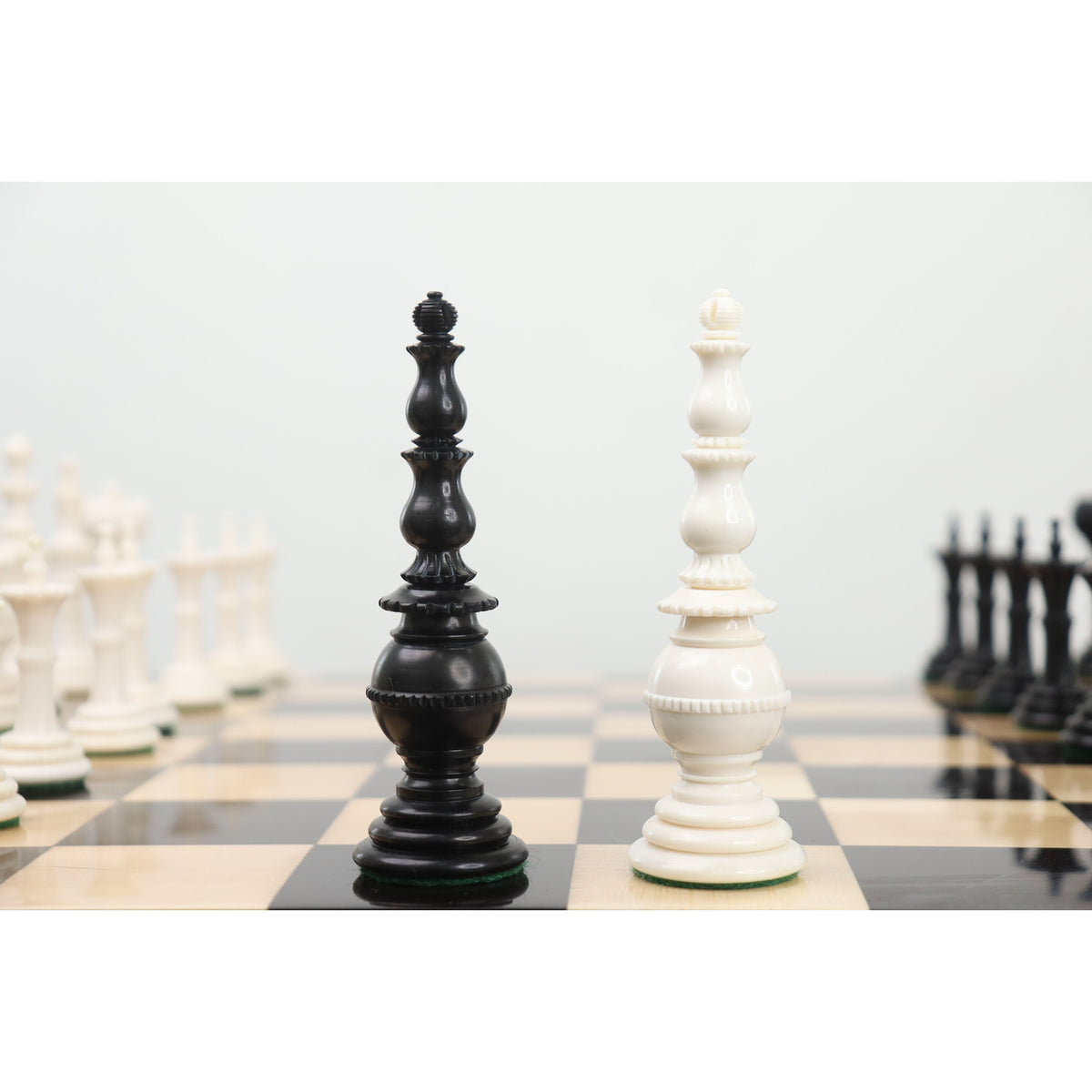 Close-up of black and white Turkish Tower king pieces on a chessboard