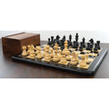 3.9 inch tournament chess pieces set set up on a premium board with a matching wooden storage box.