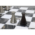 Contrast shot of a silver and antique brass metal pawn from the luxury Tower Series collection.
