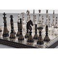 Black and silver solid brass Warli tribal artwork luxury chess set on display.