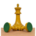White king chess piece standing tall with green felt-padded base for smooth movement