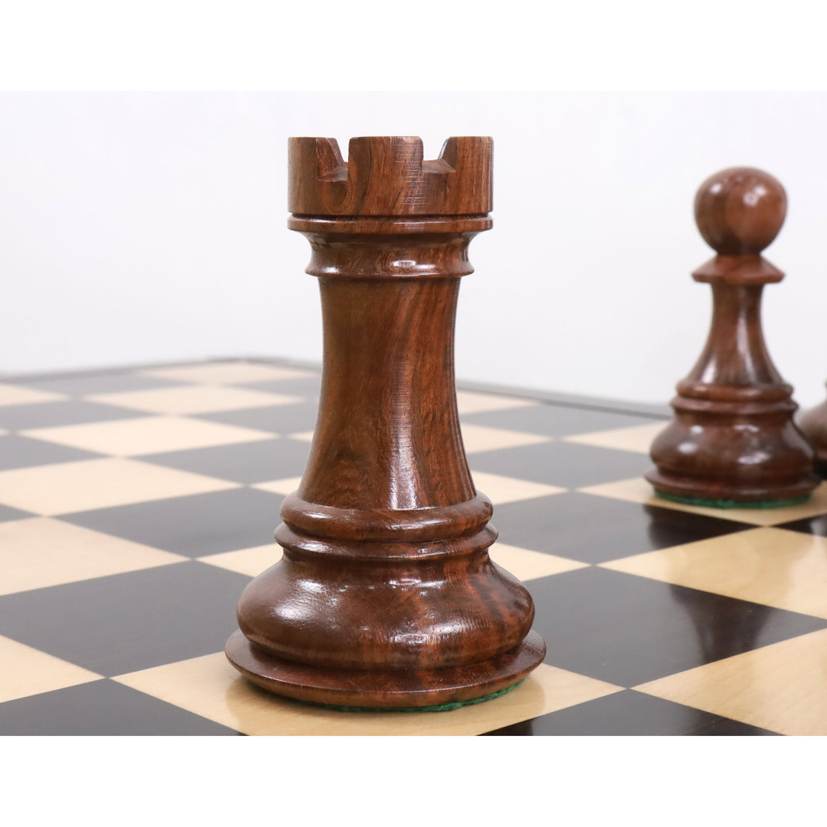 Finely carved golden rosewood Rook piece from the jumbo Pro Staunton luxury chess set.