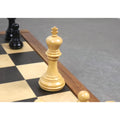 Close-up of a light wood king from the 3.8" Imperial Staunton ebony chess pieces set resting on a chessboard.