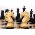 Two intricately carved Spartacus luxury Staunton knights facing each other on a chessboard.