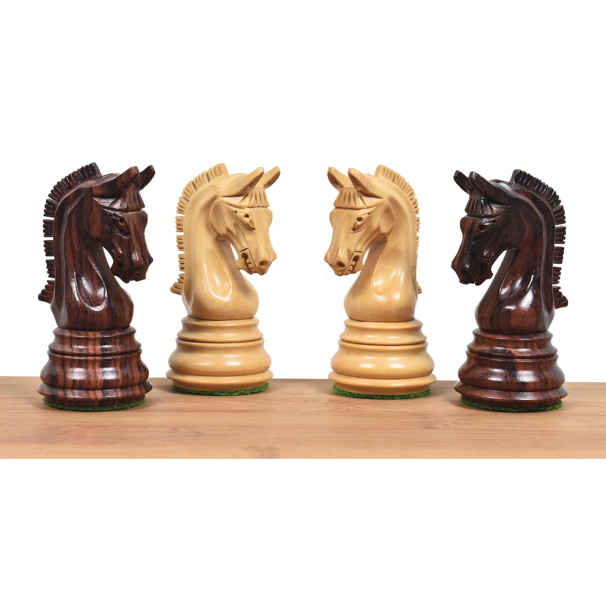 Two rosewood and two boxwood Imperial Staunton knights facing each other in profile.