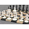 Close-up of the white King, Queen, and Rook camel bone pre-Staunton chess pieces.