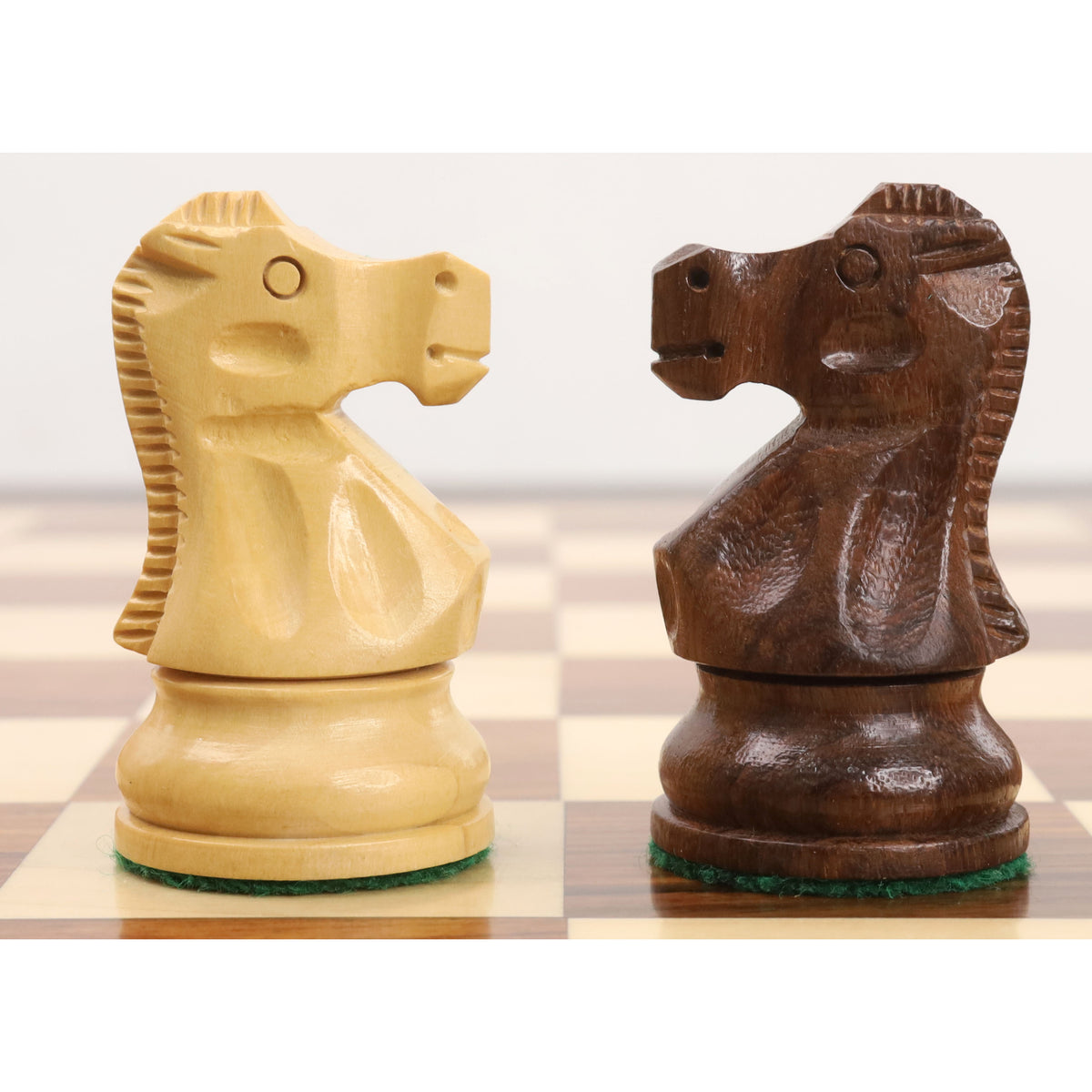 Profile comparison of boxwood and golden rosewood knights from the Reykjavik Series Staunton chess set.