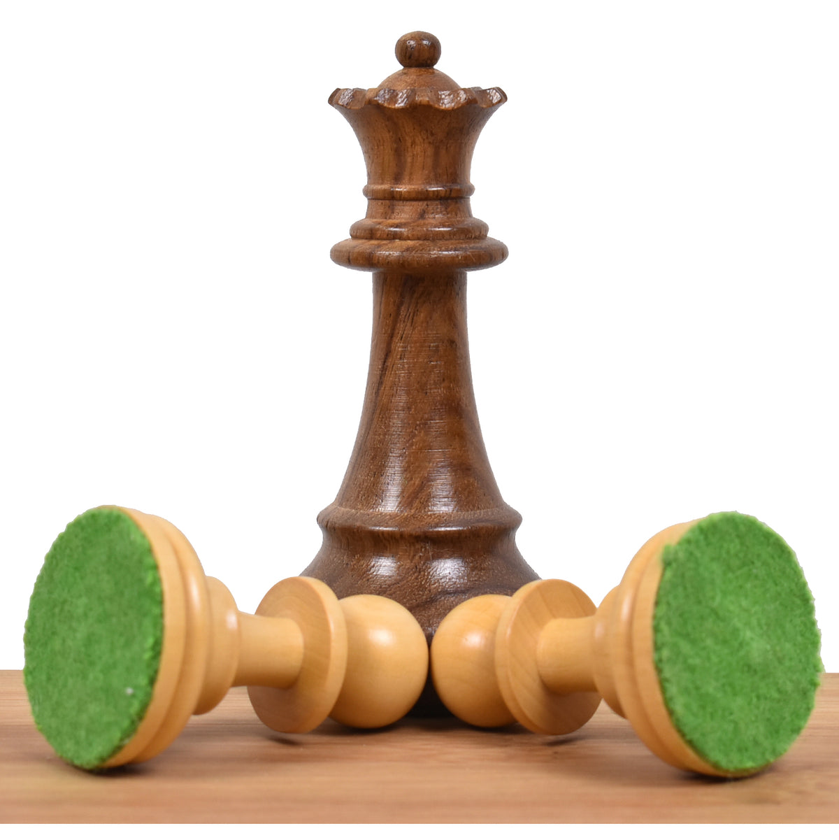 Golden rosewood French Grandmaster queen piece with two boxwood pieces showing felt bases.