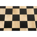 Top-down view of high-contrast Ebony and Maple wood squares on a 60 mm professional chessboard.