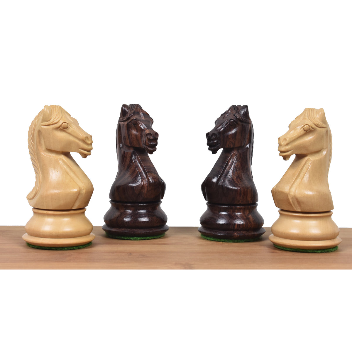 Four majestic series Staunton knights in rosewood and boxwood facing each other on wood strip.