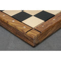 High-angle close-up of the mitered corner construction and algebraic notations on a luxury wooden chess board.