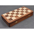 Closed folding wooden travel chess board made of golden rosewood with sturdy brass clasps for portability.