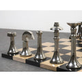 High-polished silver finish brass chess pieces including the King, Queen, and Knight on a marble board.