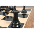 Grey brass metal rook from the luxury Jacques Staunton 1849 set resting on a chessboard.