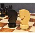 Detailed close-up of the geometric modern minimalist ebonised and natural boxwood knight chess pieces.