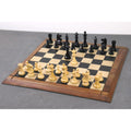 Weighted boxwood W.T. Pinney Staunton chess pieces fully set up for a game on a wooden chessboard.
