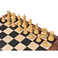 Side angle of natural boxwood Majestic Series chess pieces arranged on a wooden board.